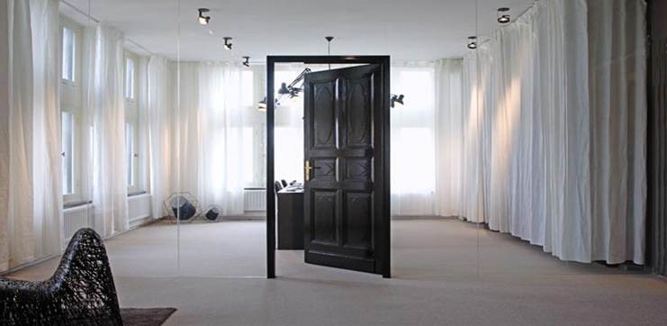 Mirrored wall with door opening into another room